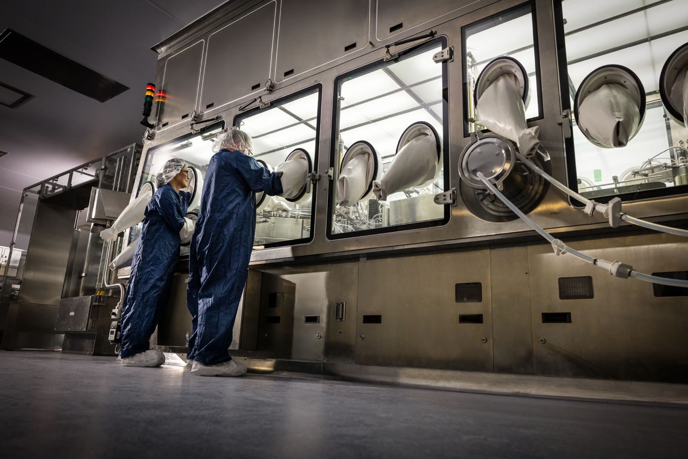 Two Lilly employees working in a modern manufacturing facility